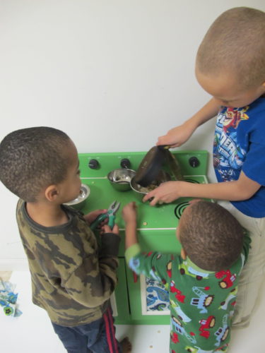 Wooden Play Kitchen Makeover - Kids playing with wooden stove. - Thrift Diving