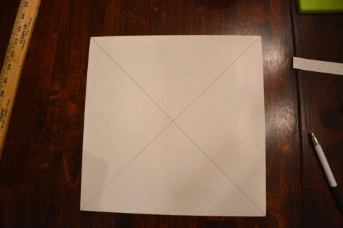 How to Make a Gift Box From Scrapbook Paper - Draw an X on the back of the scrapbook paper. - Thrift Diving