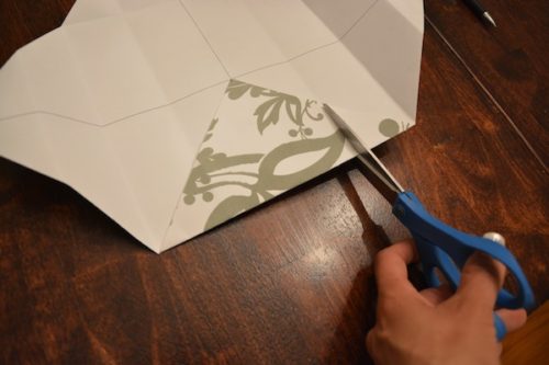 How to Make a Gift Box From Scrapbook Paper - Snip the fold up to the edge of the corner. - Thrift Diving