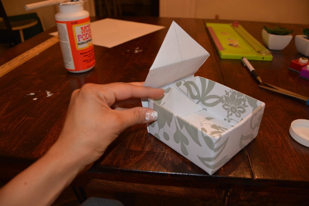 How to Make a Gift Box From Scrapbook Paper - Wrap the other flap over the other side. - Thrift Diving