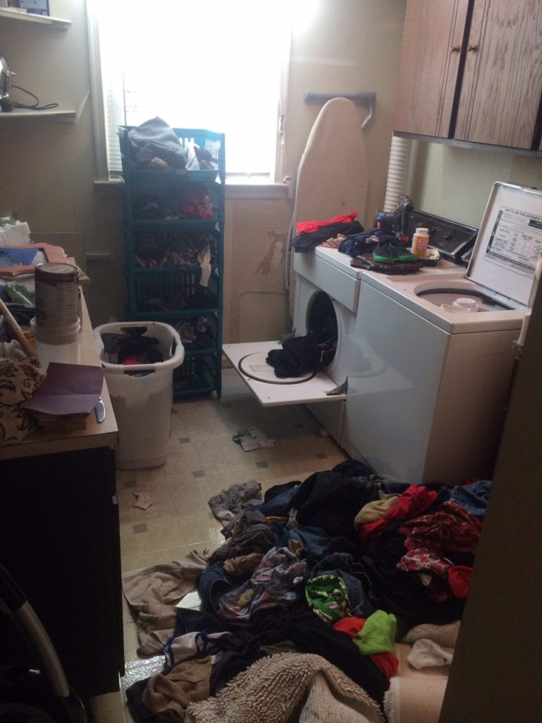 Outdated appliances, peel-n-stick floor, & lots of clothing clutter!