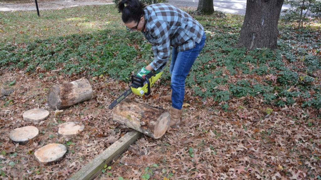 Serena with RYOBI Chainsaw cutting tree trunk - Thrift Diving