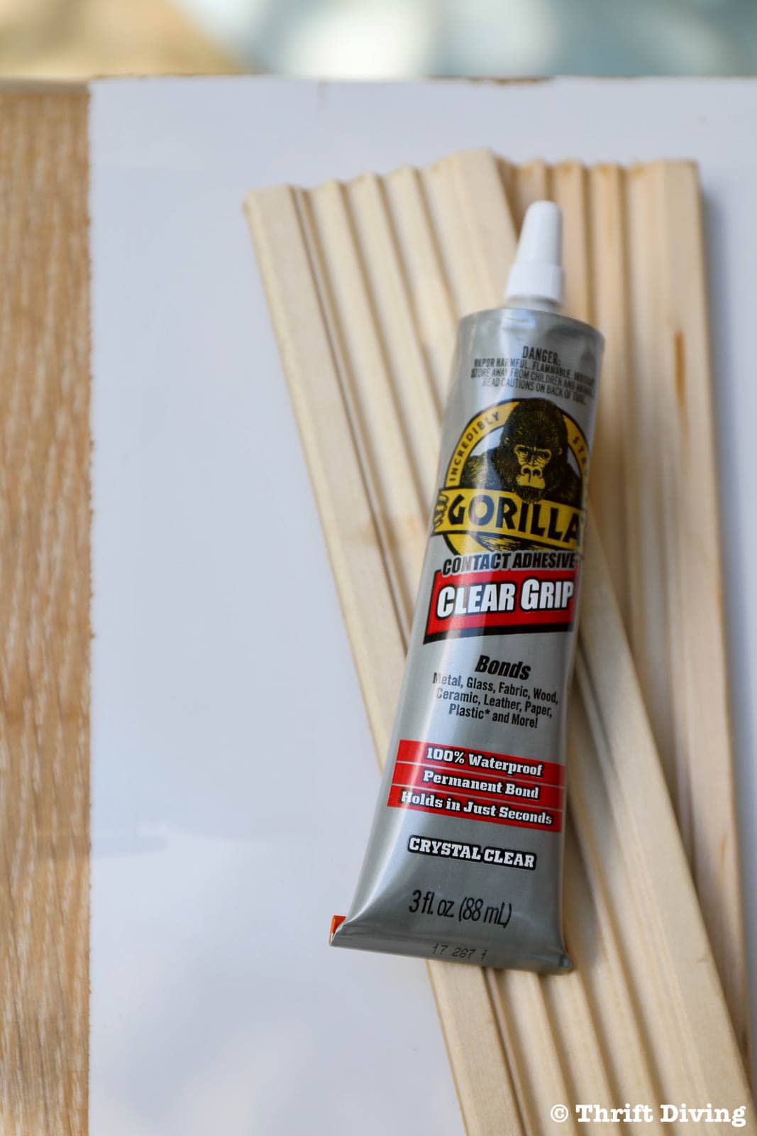 How to Make a Big DIY Whiteboard - Gorilla Clear Grip will easily adhere the trim quickly. - Thrift Diving