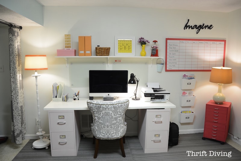 Basement Office Makeover - Use two file cabinets and an old door or countertop to create a large basement office desk, then paint it all one color. - Thrift Diving