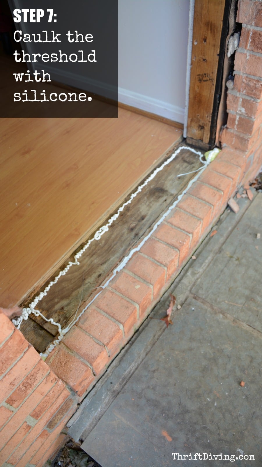 How to Replace and Paint an Exterior DIY Door - STEP 7 - Caulk around the threshold ThriftDiving.com