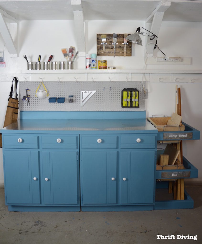 Create an upcycled garage workstation by using an old cabinet and building a scrap wood bin on the side.