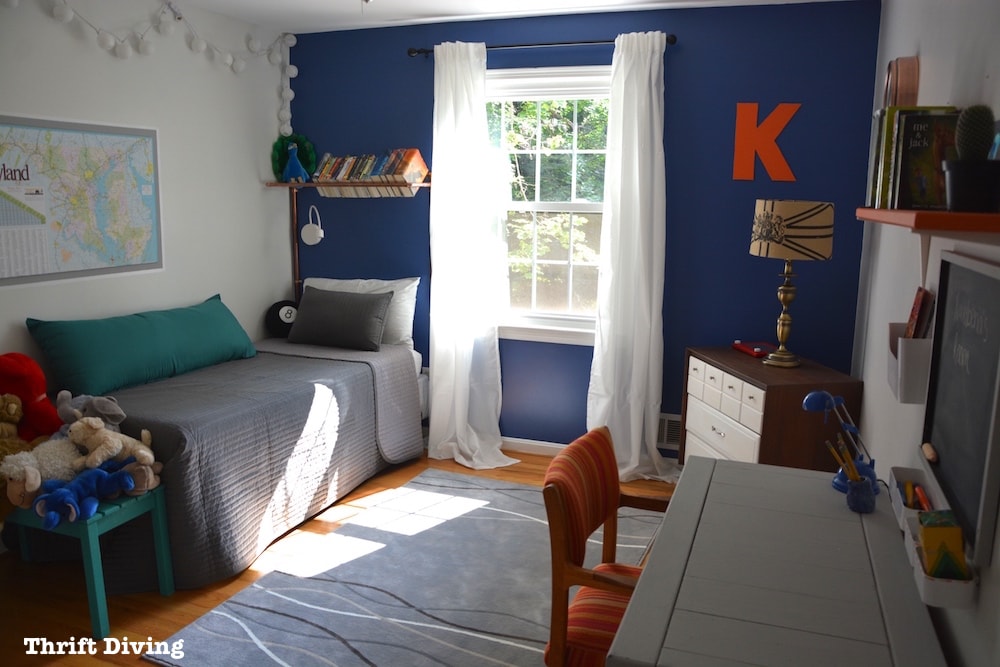 Tween Boys Blue Bedroom Makeover - This cozy boys bedroom using Behr Mosaic Blue, IKEA curtains and bedding, and a copper piping bookshelf | Thrift Diving