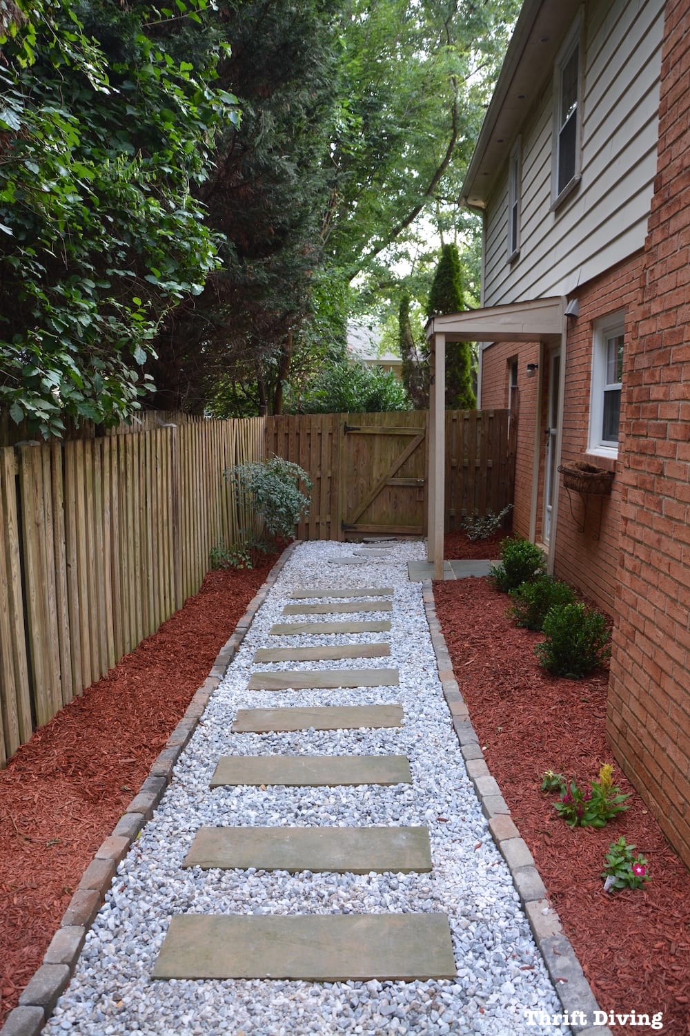 How to Create Landscape Beds - AFTER - Use edgers and mulch to define the area, with a DIY stone walkway. 