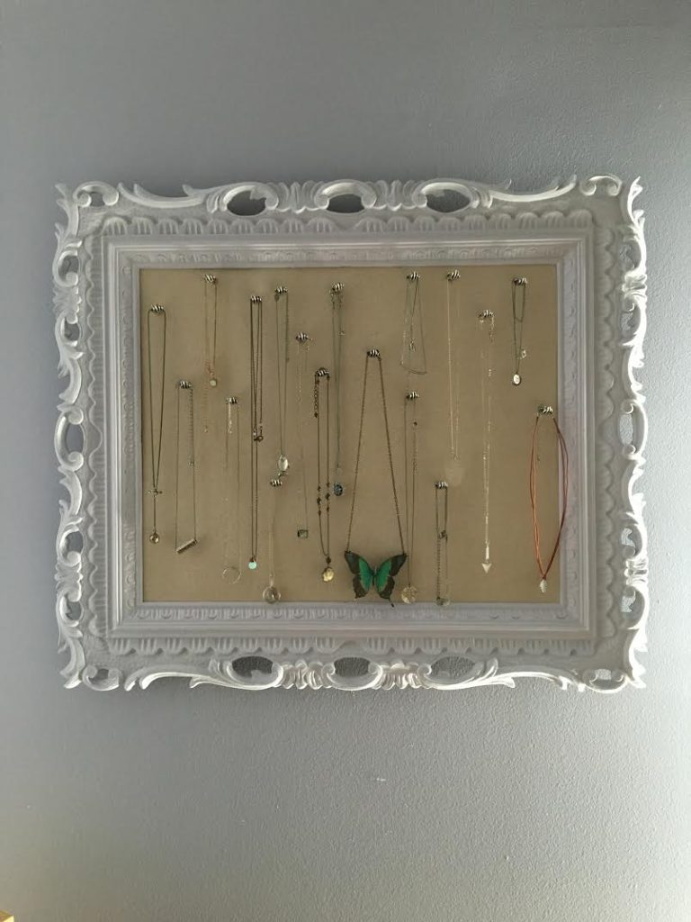 thrifted picture frame upcycled into jewelry holder for necklaces
