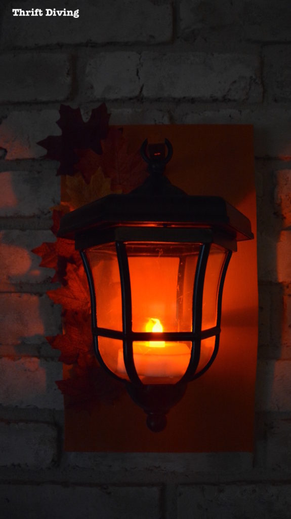DIY Lanterns Upcycled From Thrifted Path Lights - Thrift Divng Blog - Hang lanterns from a wooden plaque