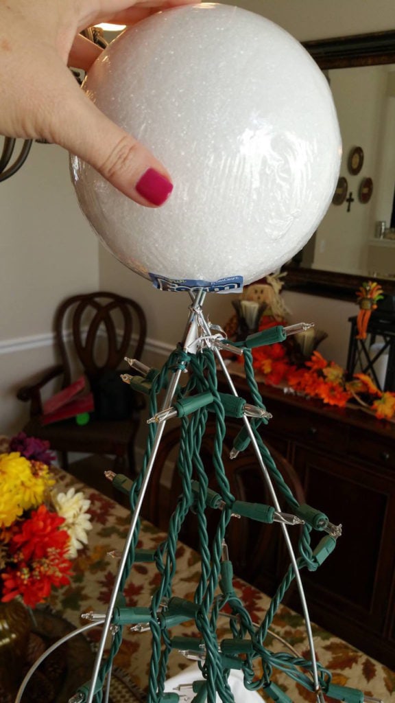 How to Make Halloween Ghost Lights For Your Front Porch - Stick foam ball on top and use twisty ties to secure lights. - Thrift Diving
