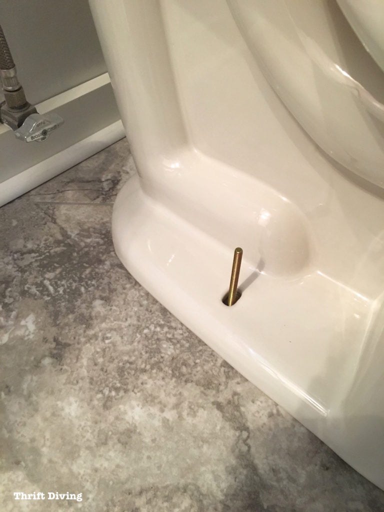 How to install a toilet yourself. Stop paying for plumbers - Line up the bolts with the toilet. - Thrift Diving