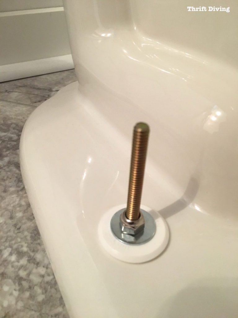 How to install a toilet yourself. Stop paying for plumbers - Place washer and bolt in order to secure the toilet to the floor. - Thrift Diving
