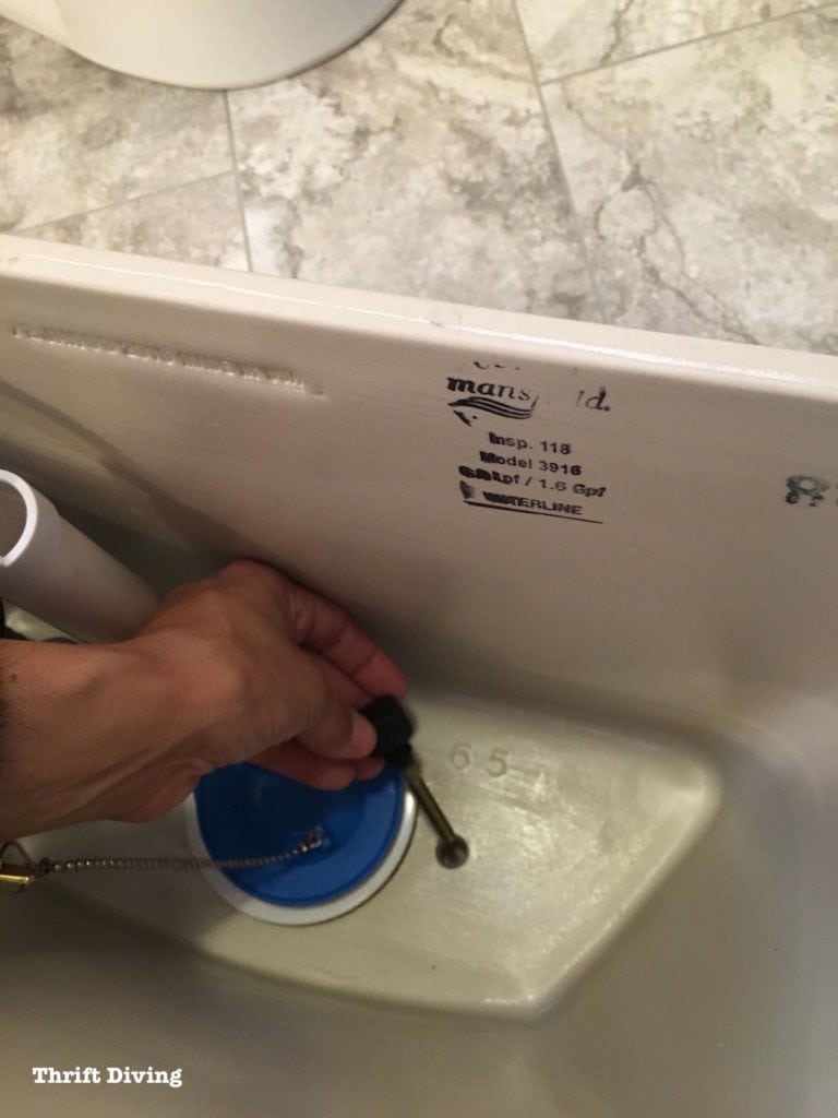 How to install a toilet yourself. Stop paying for plumbers - Secure the tank the bowl with two bolts. - Thrift Diving