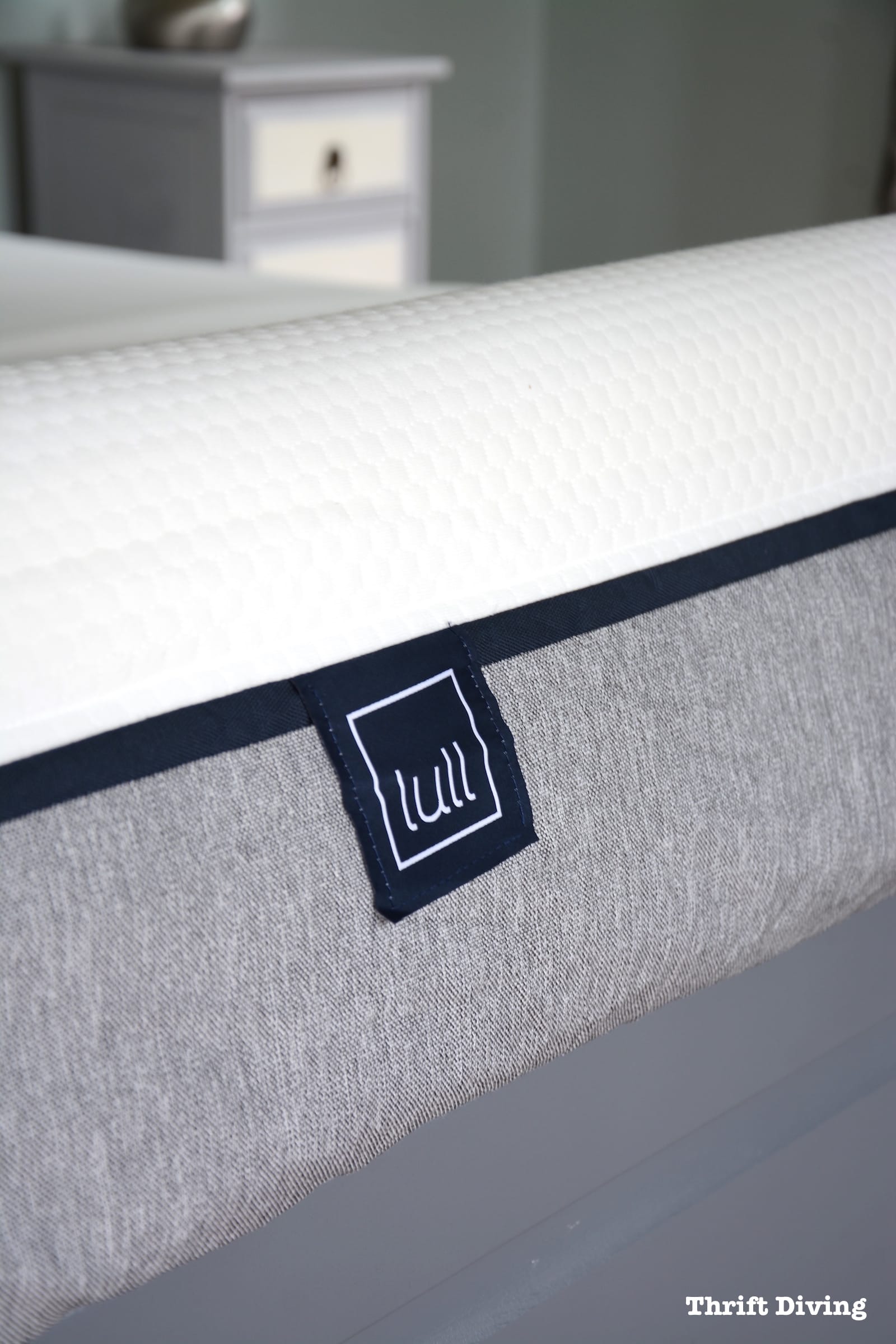 Lull Mattress Review and painted IKEA bed frame - AFTER - Lull mattress cover is gray and white with dark blue trim. - Thrift Diving