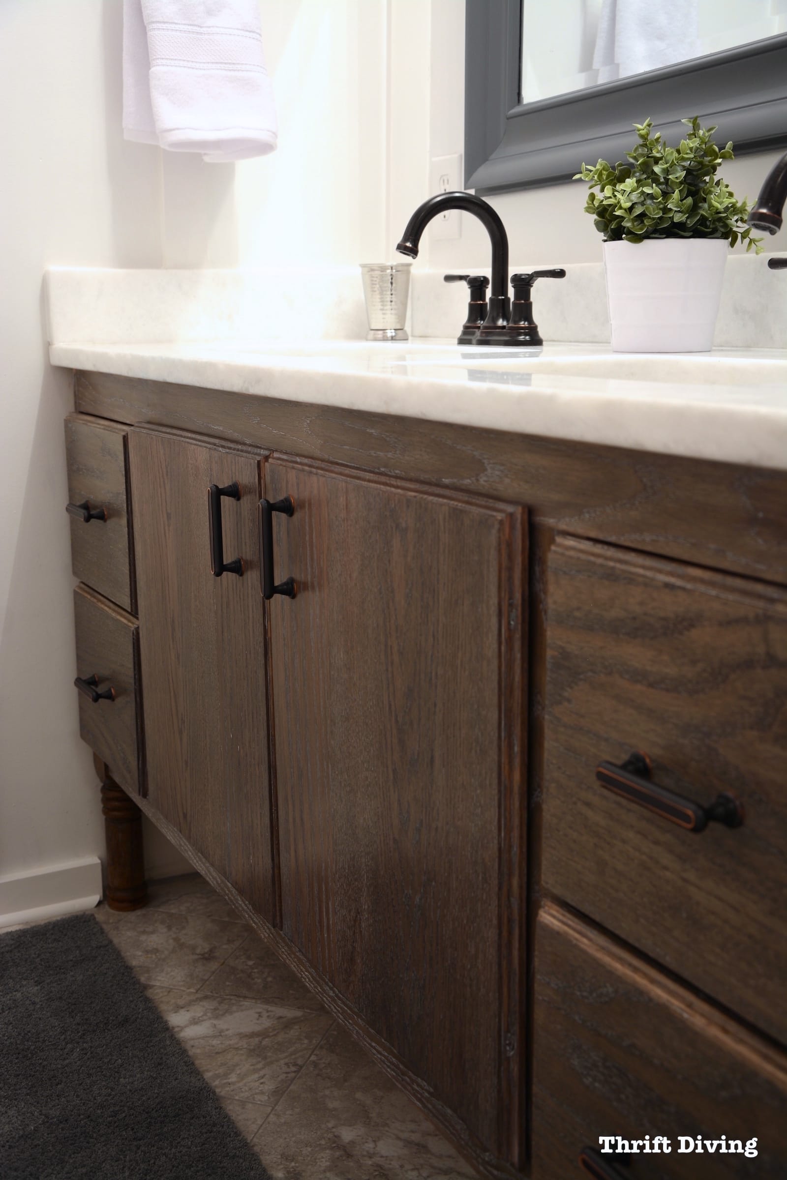 Pretty lavender bathroom makeover with a DIY bathroom vanity and lavender paint and new flooring. - Thrift Diving