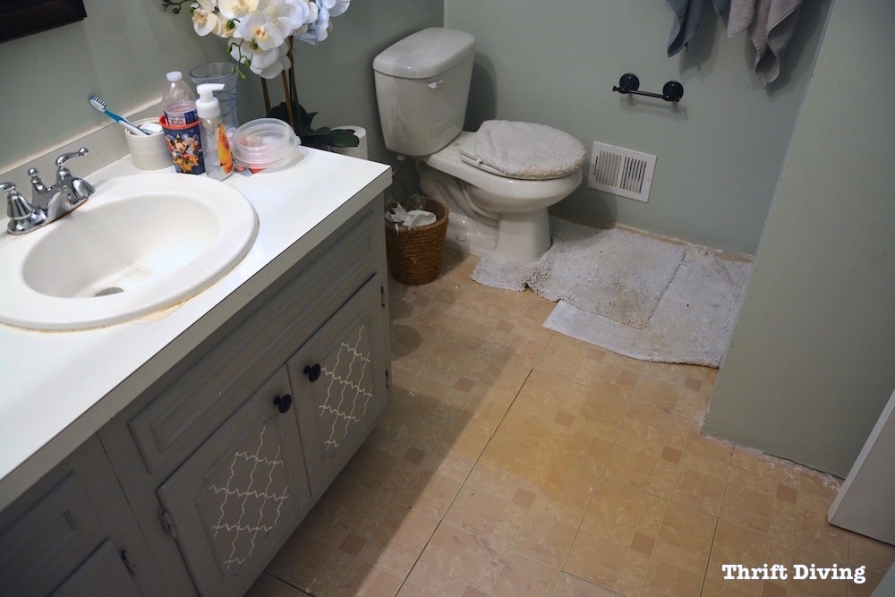 Pretty Lavender Bathroom Makeover - This is the BEFORE with ugly flooring. - Thrift Diving