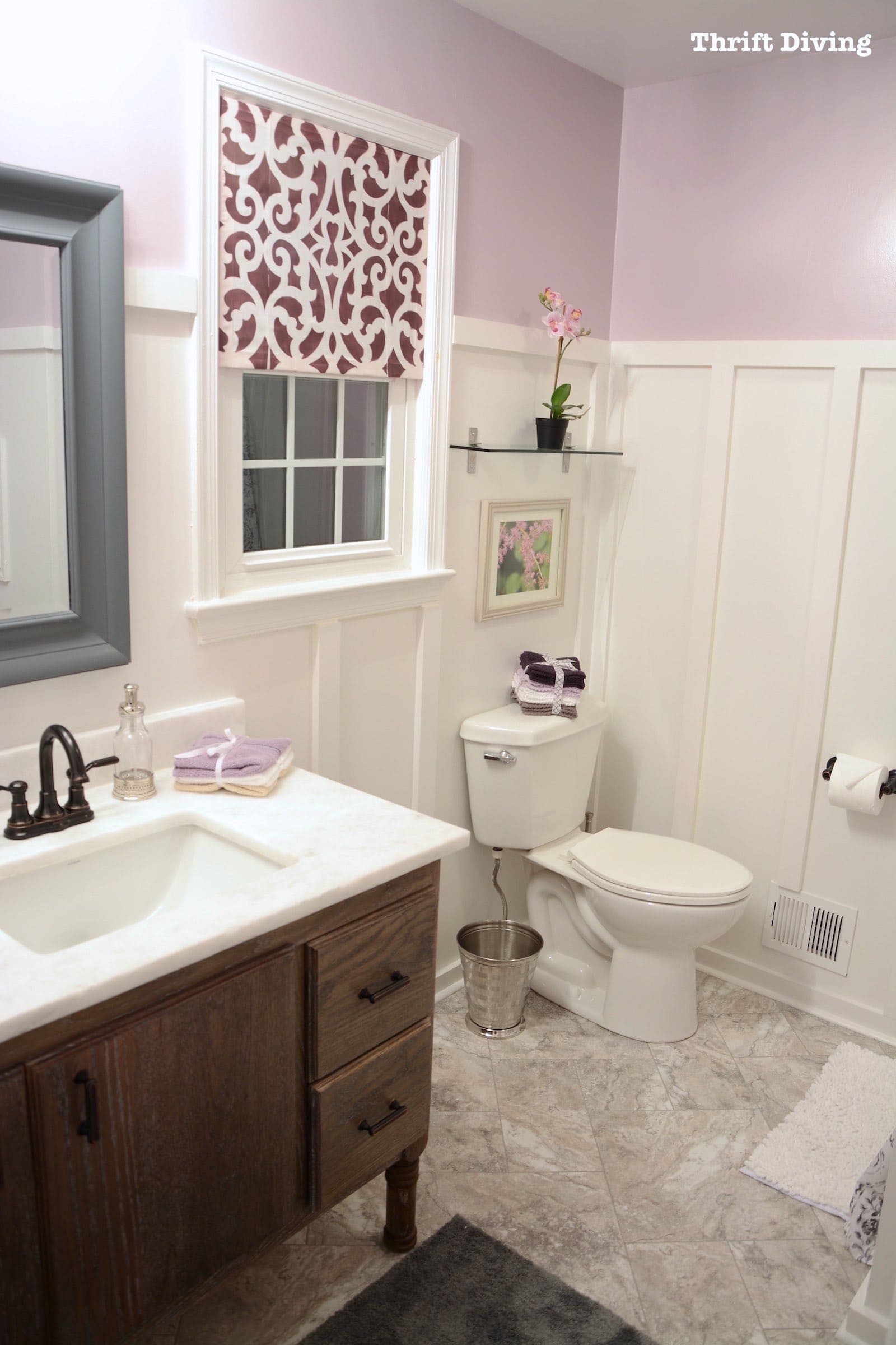 See how this master bathroom makeover was done with new flooring, a new DIY bathroom vanity built from scratch, a new DIY window privacy screen, new toilet, and painted shower! - Thrift Diving