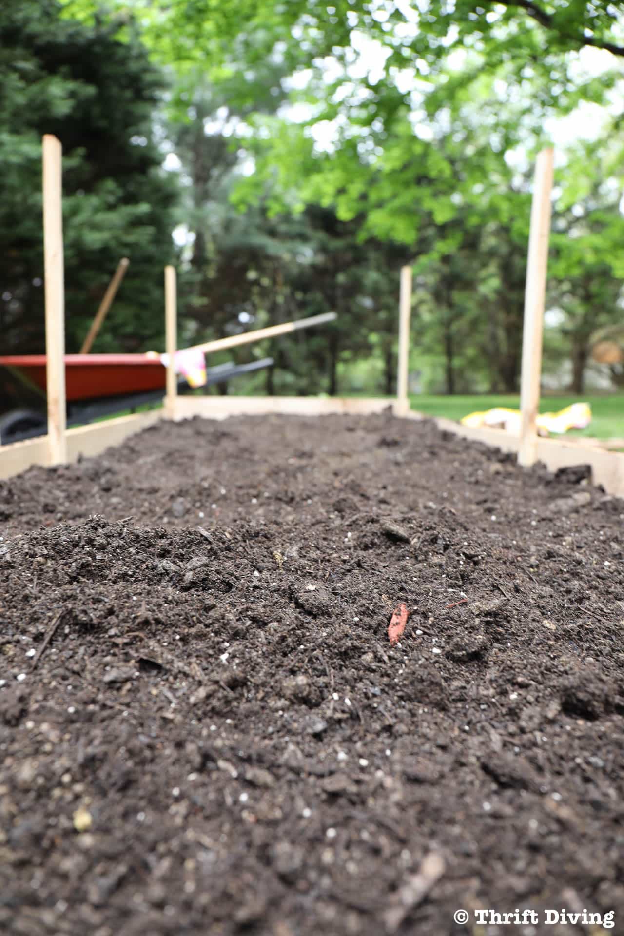 How to Build a Raised Garden Bed Protected With a Metal Fence - Use soil that has compost mixed in. - Thrift Diving