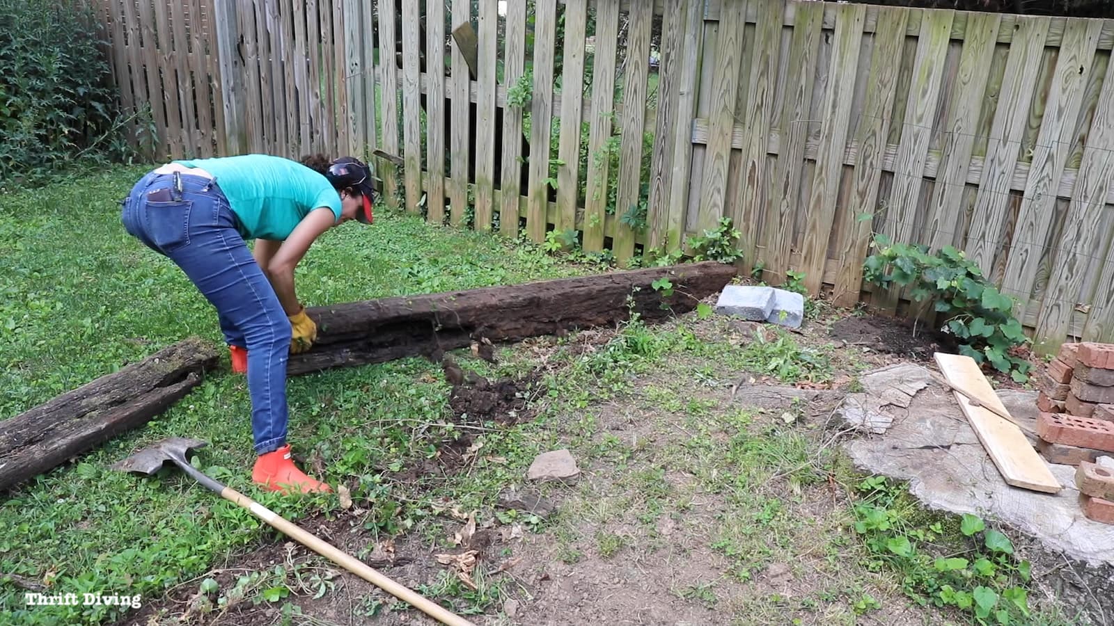 Removing cross ties to prepare a garden area.