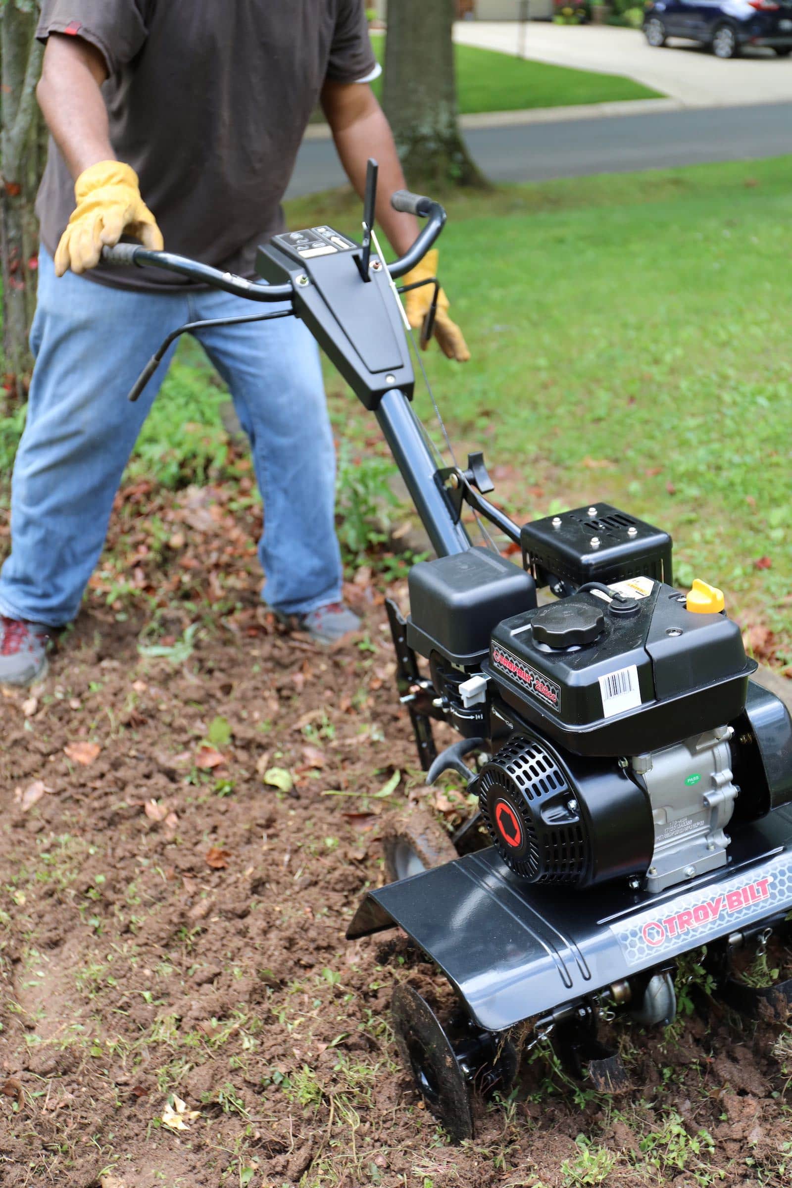 Use a gas-powered heavy-duty tiller to make it easier to build a stone walkway.