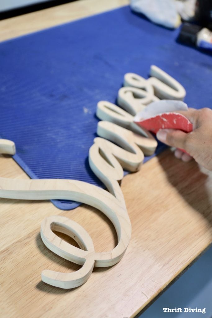 How to Make a Kitchen Sign Out of Wood: Sand the wood sign with 150 grit sandpaper. - Thrift Diving