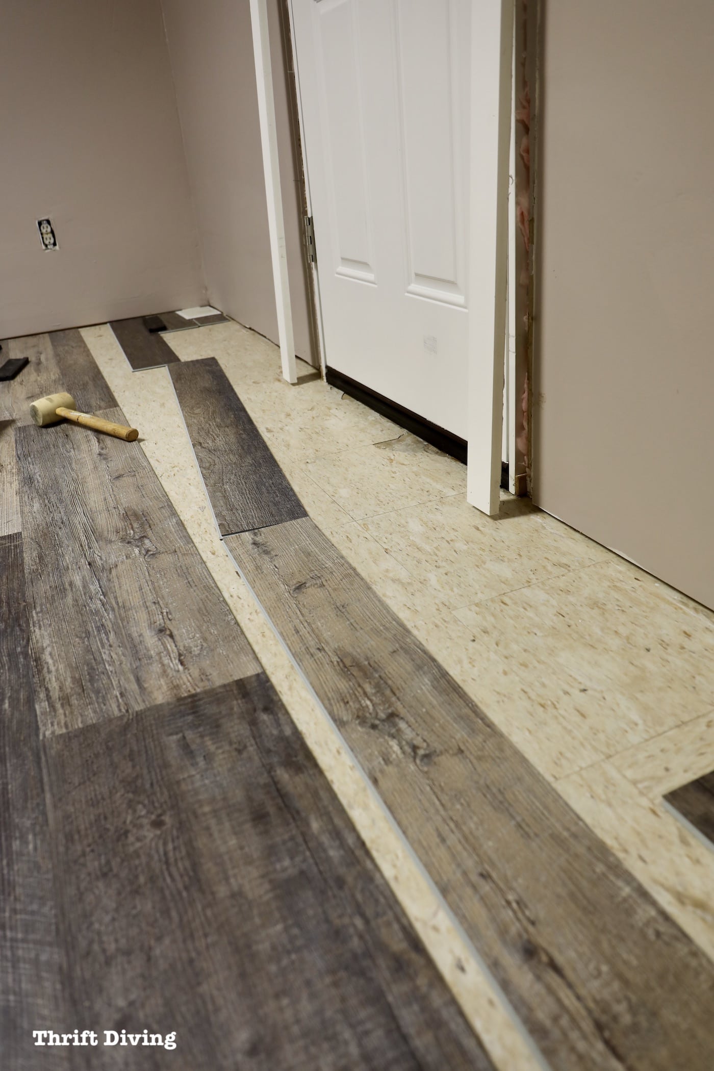 Walkout basement door with vinyl plank flooring tiles to replace - Thrift Diving