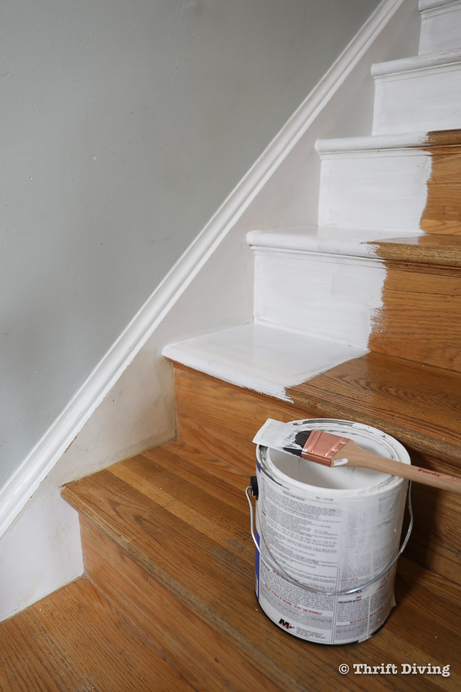 How to Install a Stair Runner - Use a paint brush and interior water-based primer to prime your wood stairs before painting. - Thrift Diving