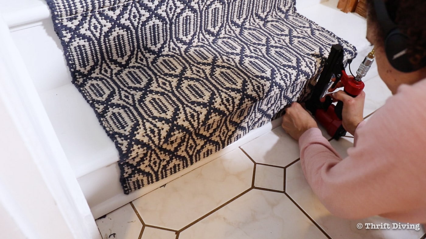How to Install a Stair Runner - At the end of the staircase, secure with staples at the bottom rise, folding under a couple of inches. - Thrift Diving 