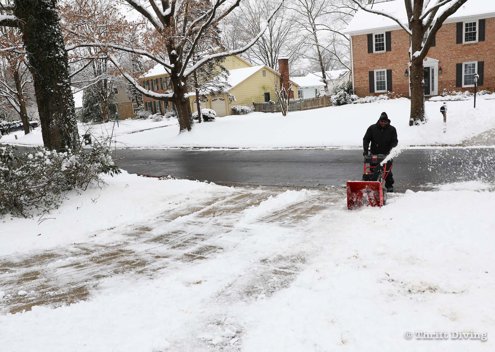 5 Questions You Must As Before Buying and Using a Snowblower - Snow blowing a driveway - Thrift Diving