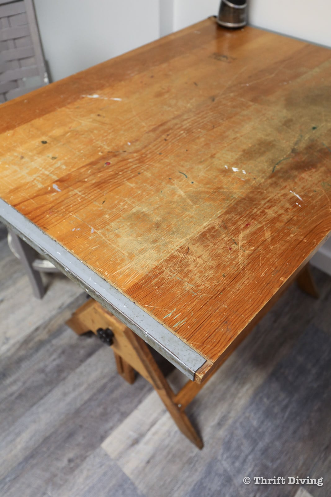 How to Refinish Wood Furniture with Eco-Friendly Stripper and Stain - This is the "before" of the Anco Bilt vintage drafting table found at the thrift store for only $30! The table top needed to be refinished: stripped, sanded, stained, and waxed. - Thrift Diving
