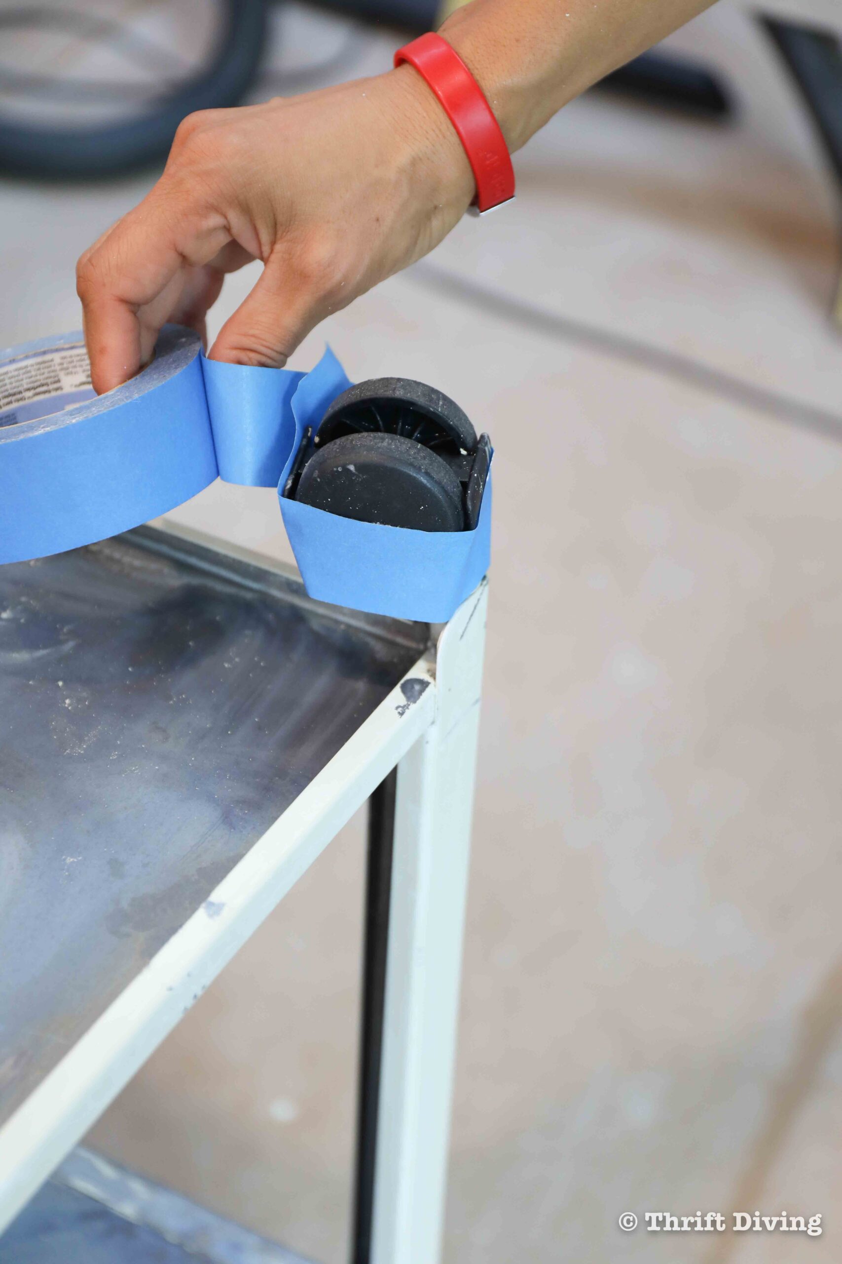 How to Paint a Metal File Cabinet - Tape off areas to protect it from spray paint. - Thrift Diving