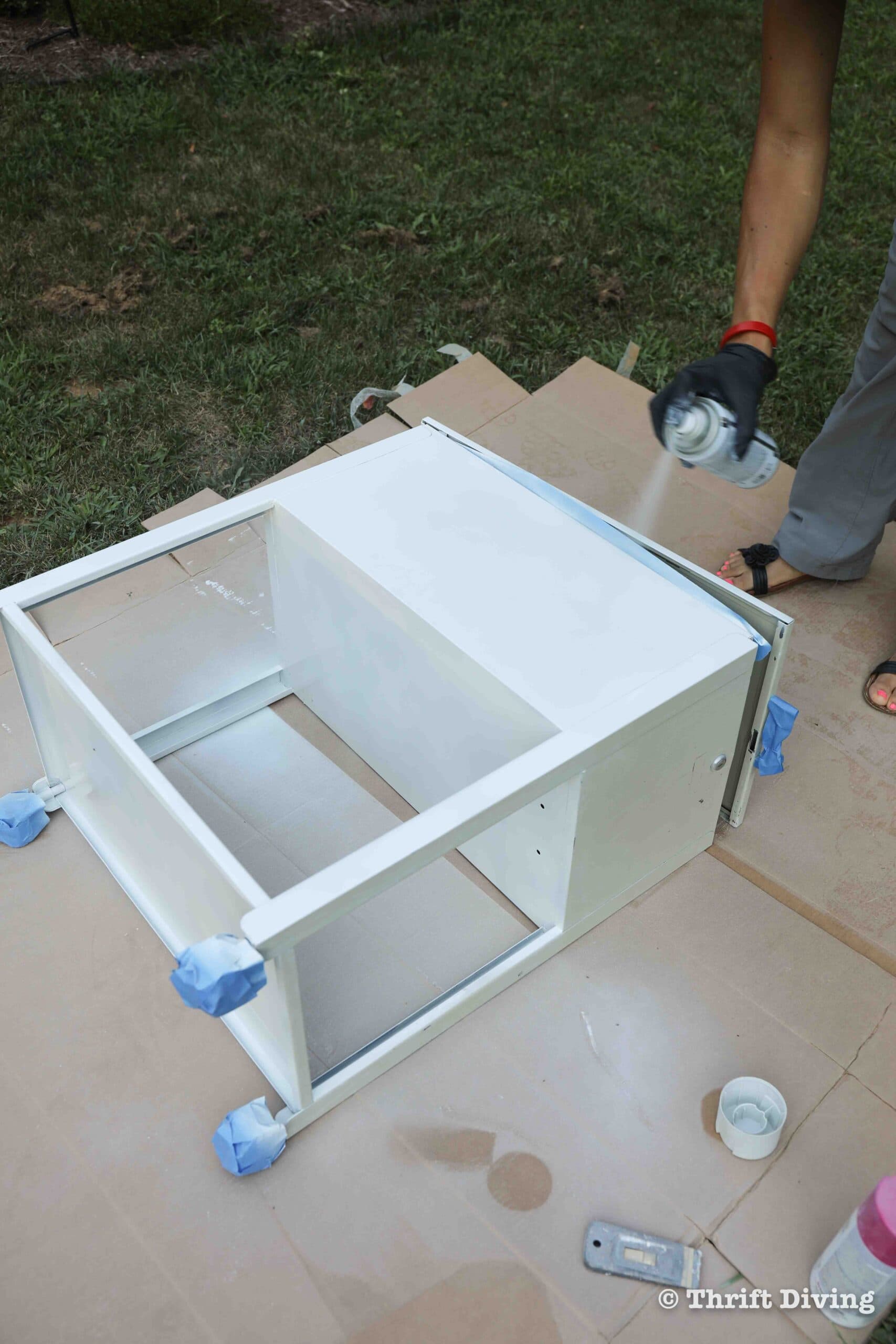 How to Paint a Metal File Cabinet - Spray paint is best applied on surfaces laying flat to prevent runs. - Thrift Diving