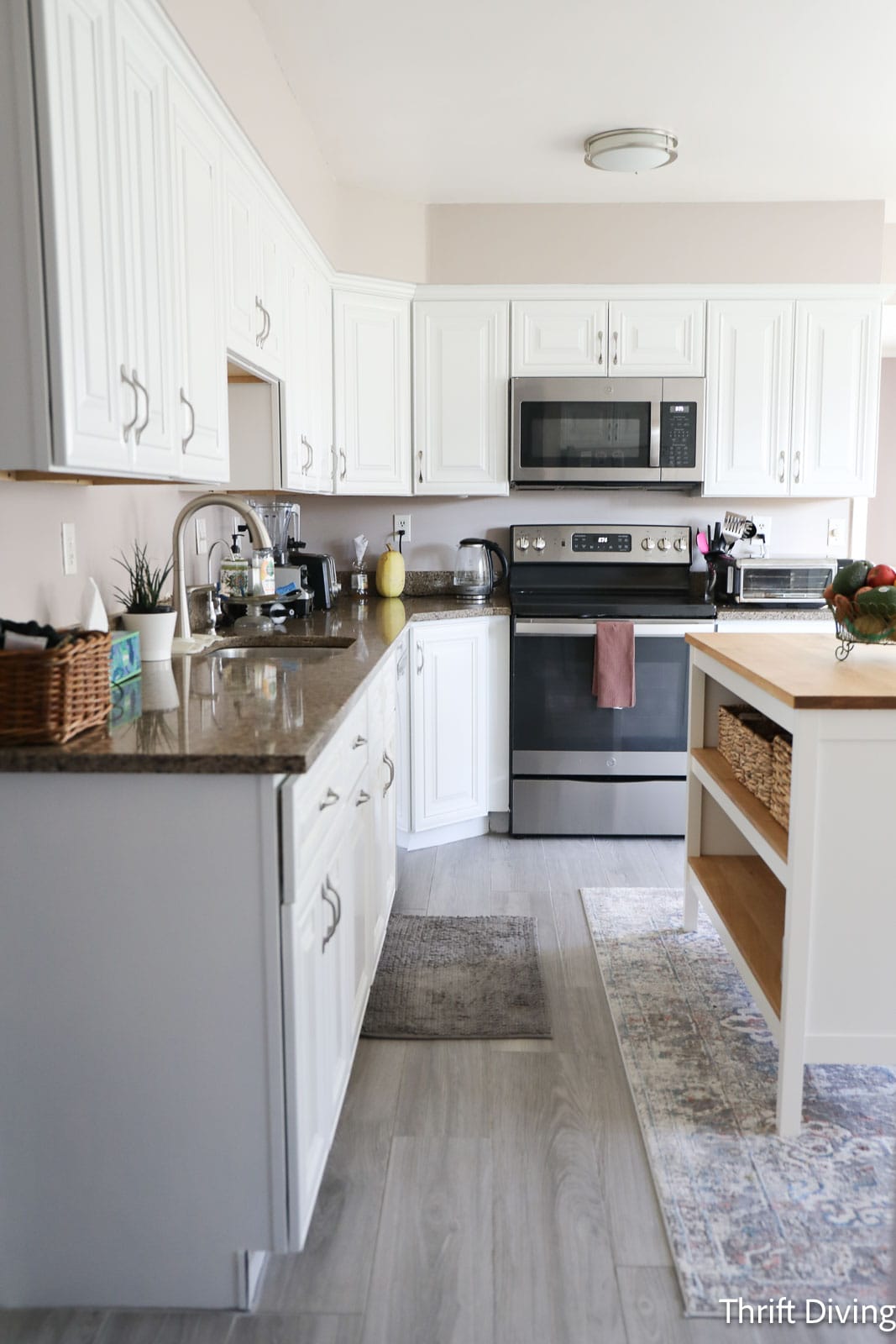 white kitchen cabinets with gray tile floor