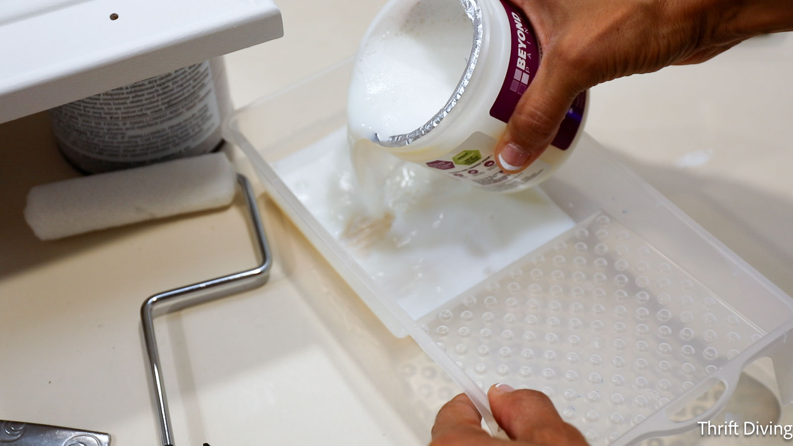 How to Paint Kitchen Cabinets White - Pouring sealer into a tray.