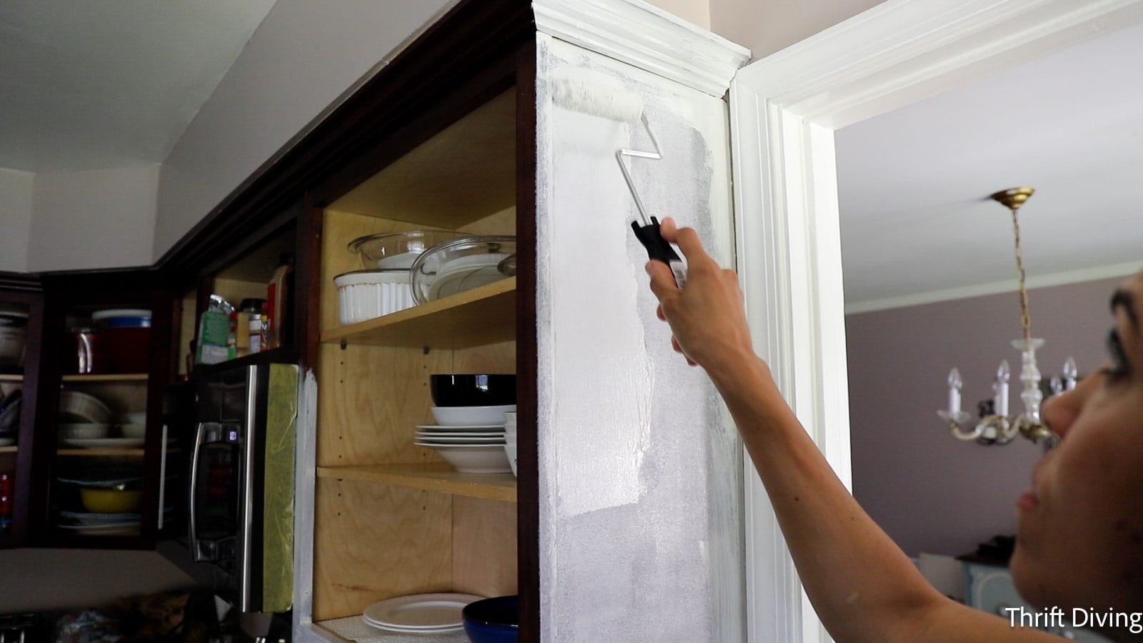How to Paint Kitchen Cabinets White - Priming with a roller.