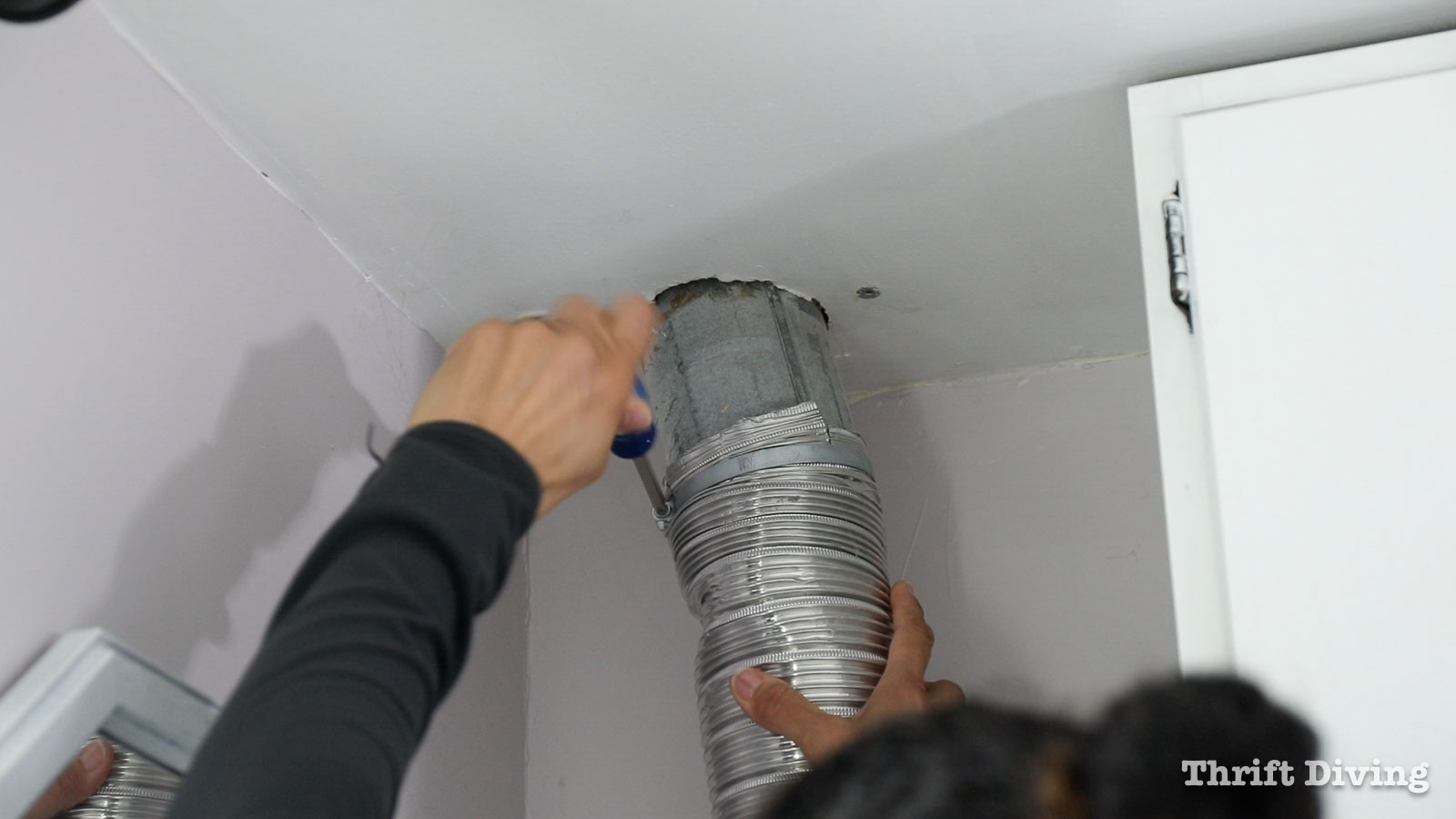 Removing the dryer hose before cleaning dryer vents. - 7 Home Maintenance Tasks - Thrift Diving