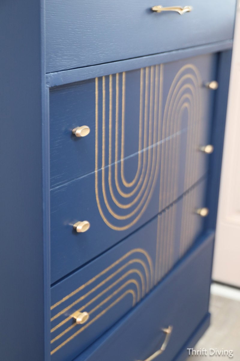 Blue painted dresser with gold stencil design after removing musty smell.