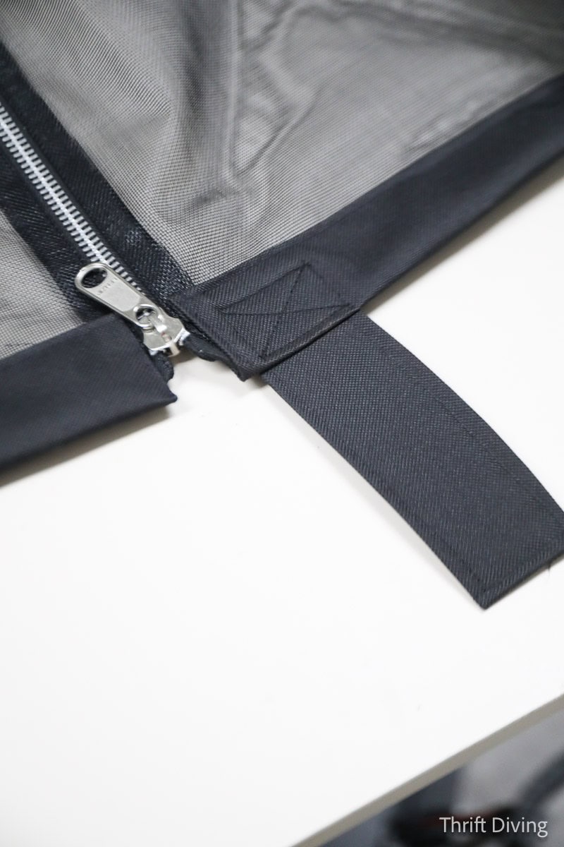 How to Make DIY Gazebo Screens - A foot tab at the bottom of a gazebo screen with a zipper and black binding along the edges.