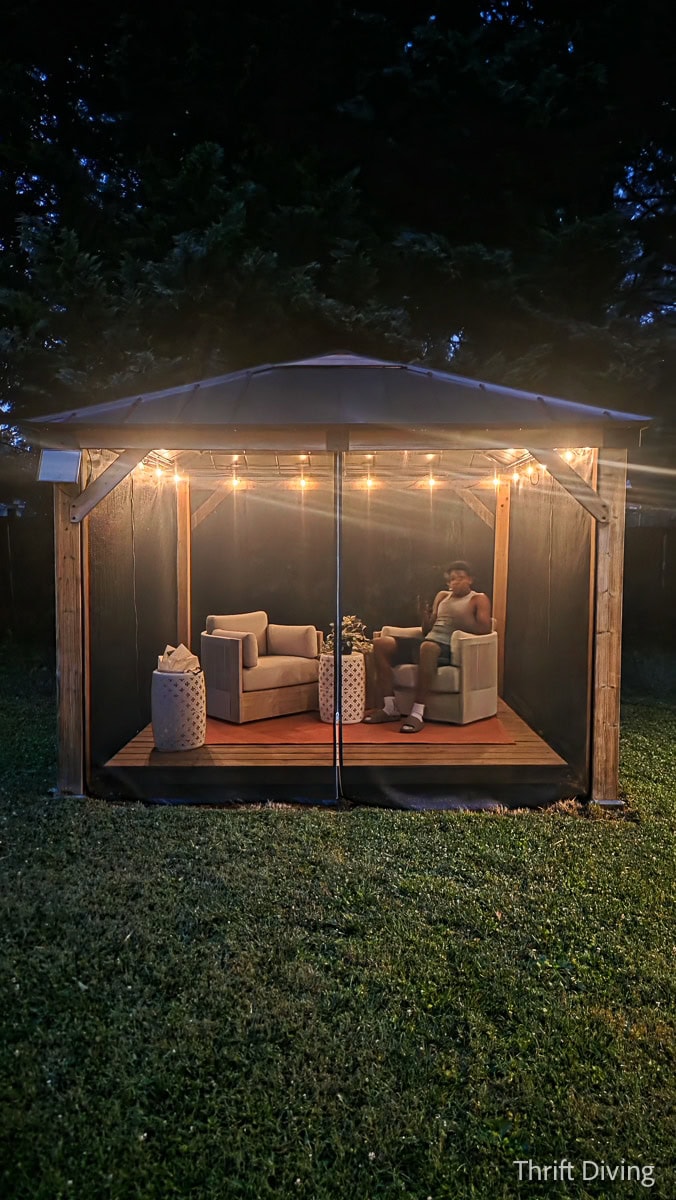How to Make DIY Gazebo Screens - Backyard outdoor gazebo with gazebo screens at night with cozy gazebo lighting.