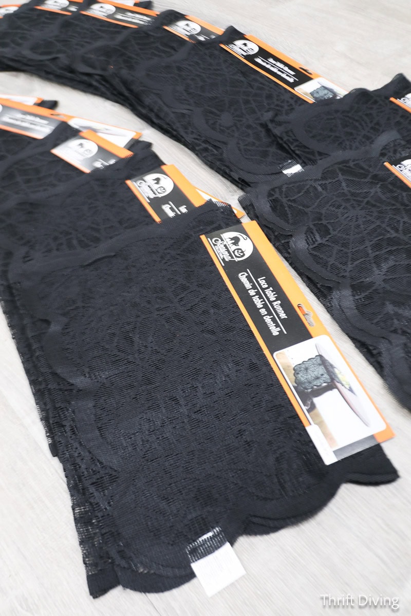 Dollar Tree lace Halloween table runners in a stack.