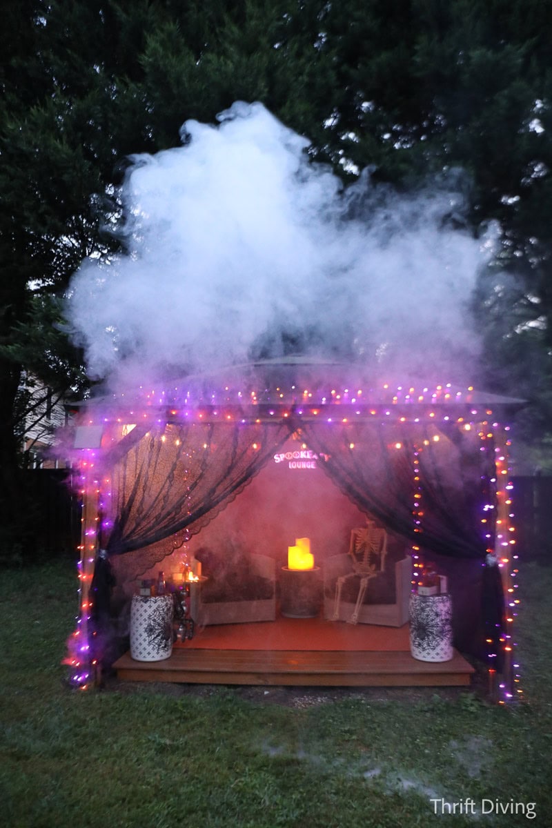 Foggy gazebo decorated with Halloween lights and a moody vibe.